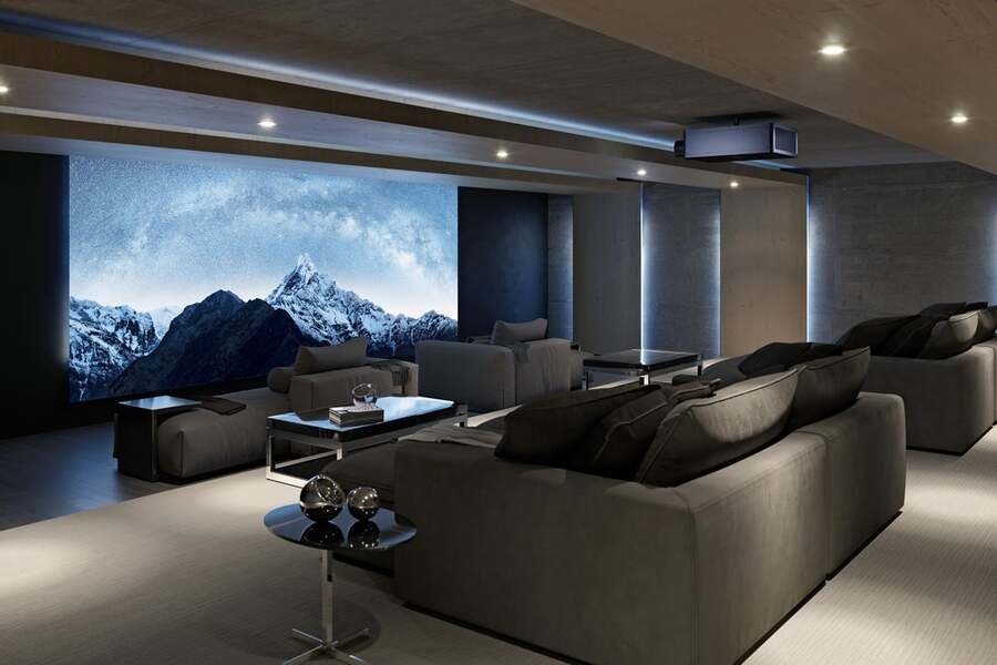 A luxury home theater with a Sony projector displaying a natural landscape.