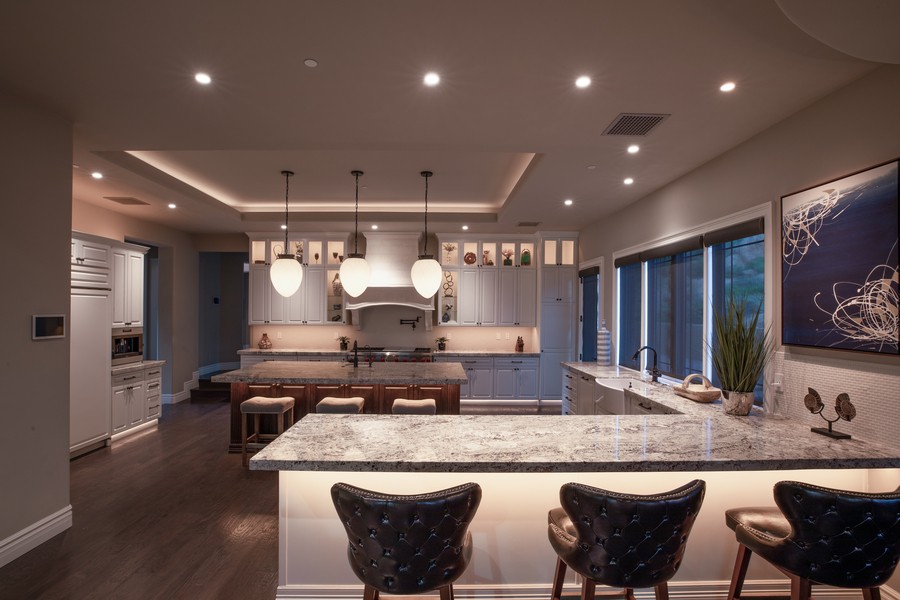 a modern kitchen with lighting mounted under the counter and cabinets.